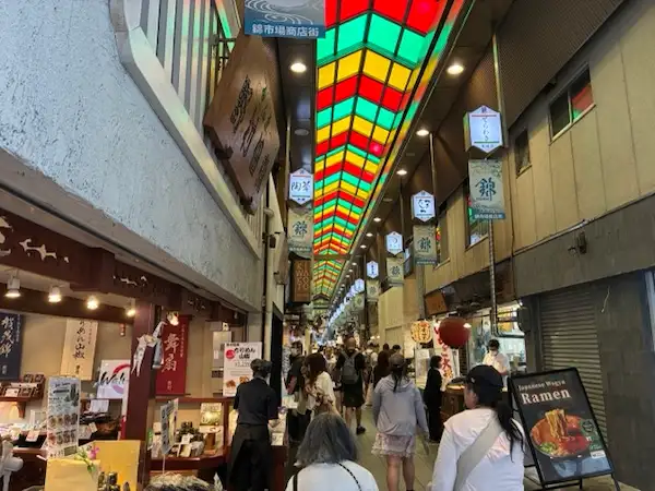 The covered Nishiki Market arcade in Kyoto, known for its colorful ceiling and food stalls