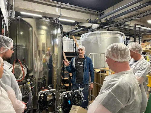 Brewer Jorge explains the fermentation tanks during the English-guided brewery tour at Matsui Sake Brewery in Kyoto