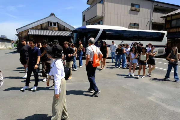 U.S. university students arriving by bus at Matsumoto Sake Brewery in Fushimi, Kyoto