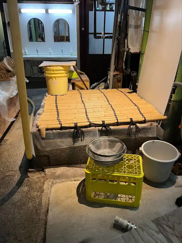 Bamboo mats and traditional tools used for rice steaming and koji preparation